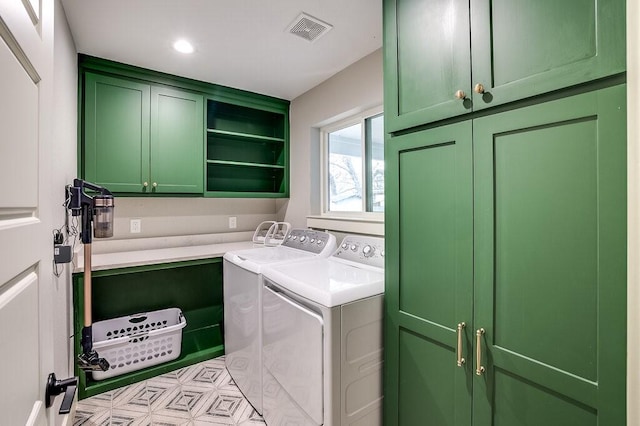 laundry room featuring cabinets and washer and dryer