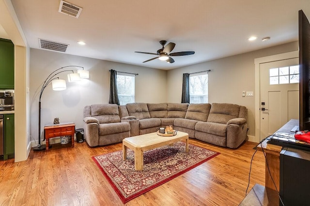 living room featuring ceiling fan and light wood-type flooring