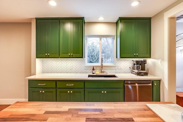 kitchen featuring tasteful backsplash, sink, dishwasher, and green cabinets