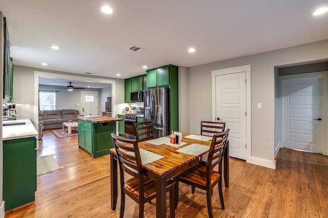 dining space featuring ceiling fan and light hardwood / wood-style flooring