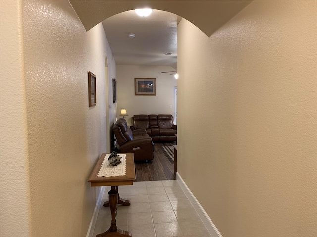 hall featuring light tile patterned floors