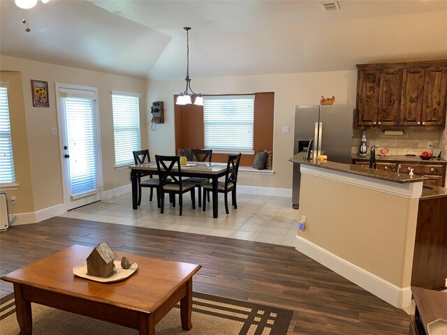 living room with vaulted ceiling and light hardwood / wood-style flooring