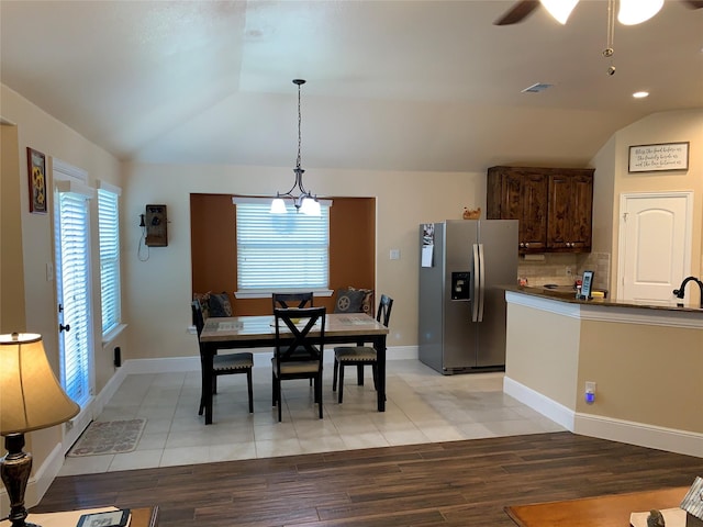 tiled dining area with lofted ceiling