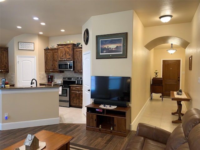 living room with sink and light hardwood / wood-style flooring