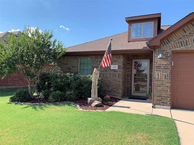 view of front of home featuring a garage and a front lawn