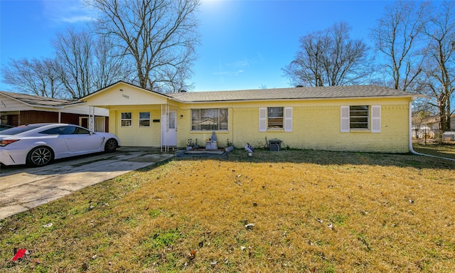 ranch-style home with a carport and a front yard