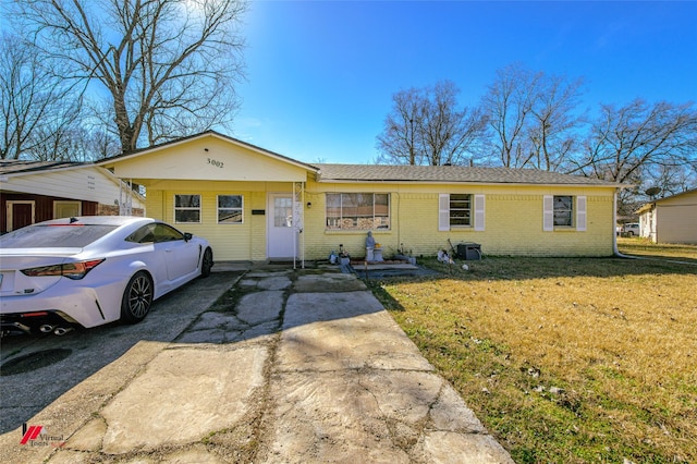 single story home with a carport and a front lawn