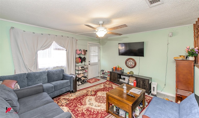 living room with ornamental molding, a textured ceiling, and ceiling fan