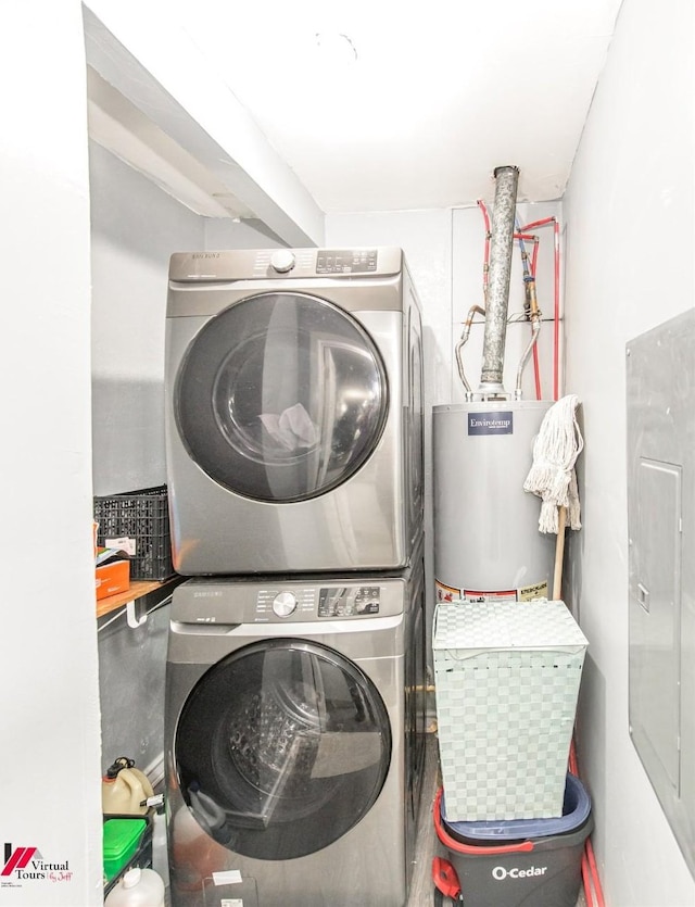 laundry room with stacked washer / drying machine, electric panel, and gas water heater