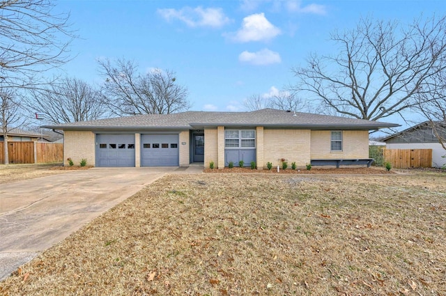 ranch-style house featuring a garage and a front lawn