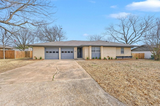 single story home with a garage and a front lawn