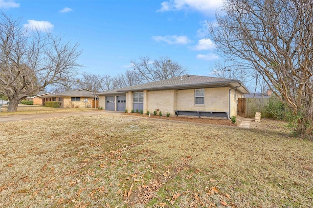 ranch-style home featuring a garage and a front yard