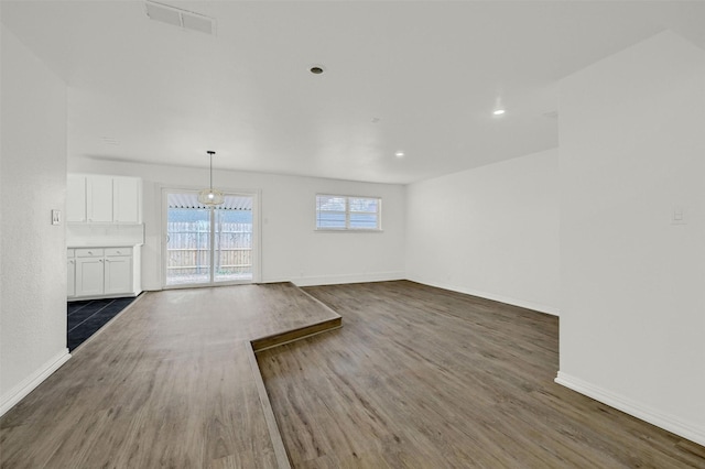 unfurnished living room featuring dark hardwood / wood-style flooring