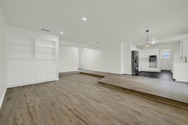 unfurnished living room featuring dark hardwood / wood-style floors