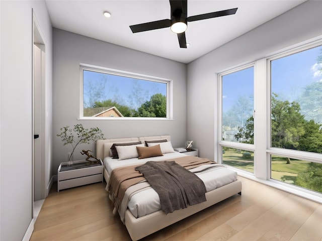 bedroom featuring ceiling fan and light hardwood / wood-style floors