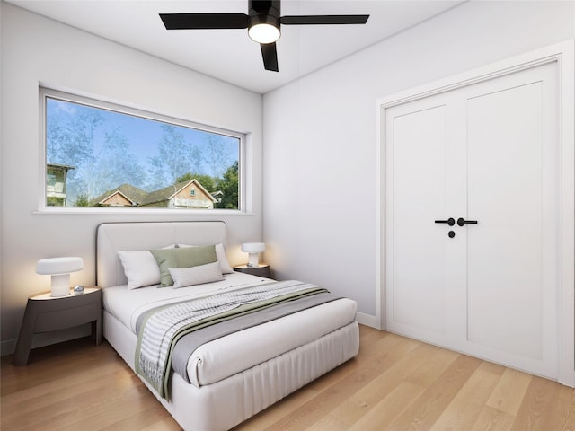 bedroom with multiple windows, light hardwood / wood-style floors, a closet, and ceiling fan