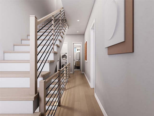 corridor featuring hardwood / wood-style flooring and washer / dryer