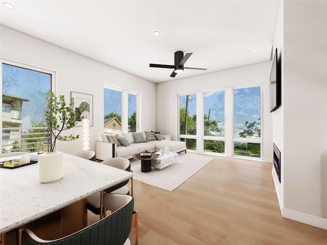 living room featuring ceiling fan and light wood-type flooring