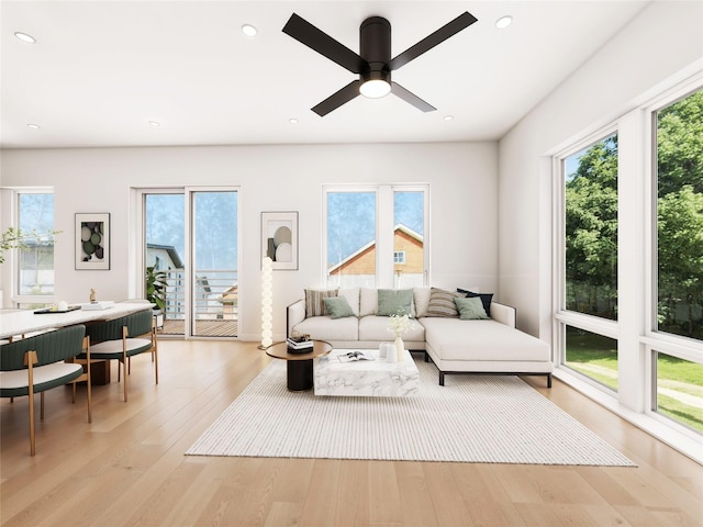 living room with ceiling fan, light hardwood / wood-style floors, and a healthy amount of sunlight