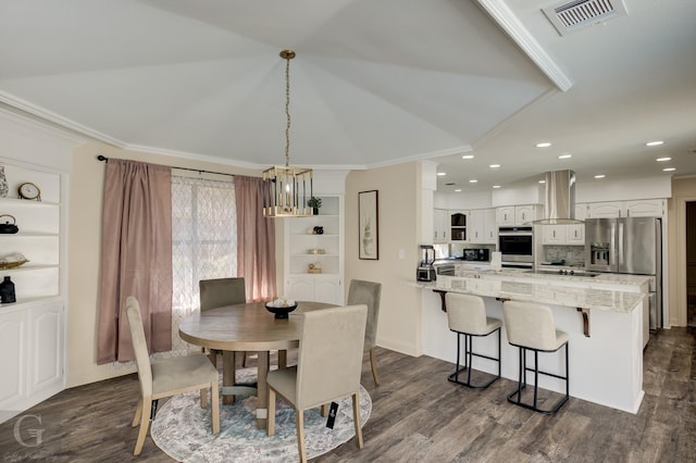 dining area with ornamental molding and dark hardwood / wood-style floors