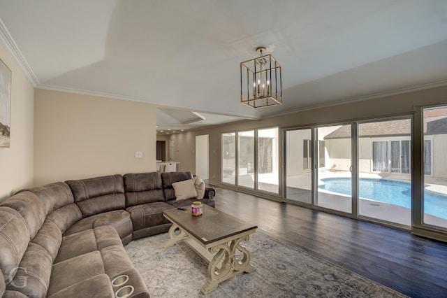 unfurnished living room with ornamental molding, wood-type flooring, and a notable chandelier