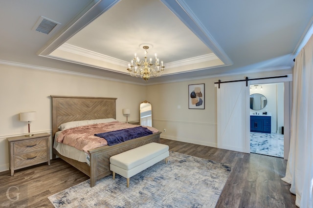 bedroom featuring dark hardwood / wood-style floors, a barn door, a raised ceiling, and an inviting chandelier