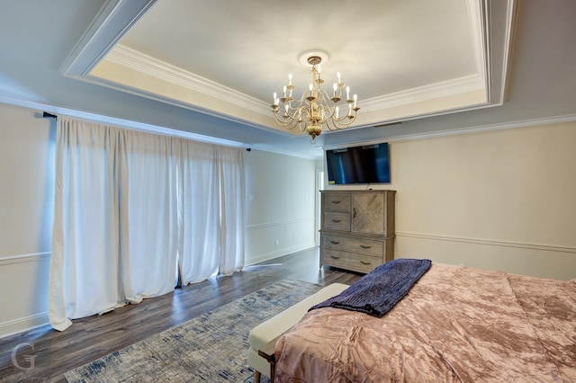 bedroom featuring a raised ceiling, crown molding, dark wood-type flooring, and a chandelier