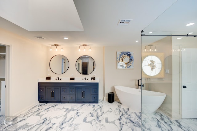 bathroom featuring vanity and a tub