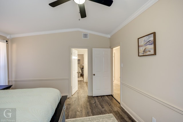 bedroom with crown molding, lofted ceiling, dark wood-type flooring, and ceiling fan