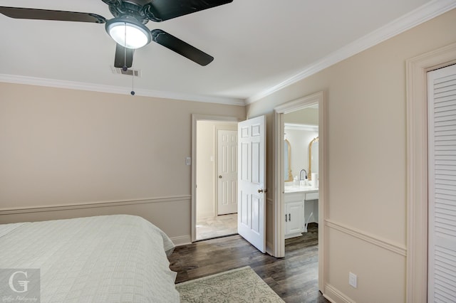 bedroom featuring sink, ceiling fan, dark hardwood / wood-style floors, connected bathroom, and ornamental molding