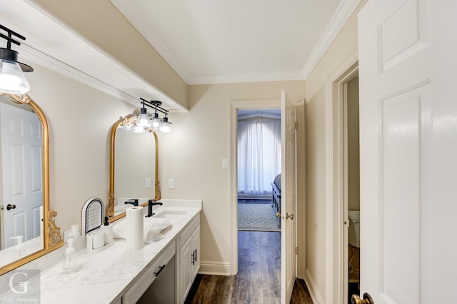 bathroom featuring crown molding, wood-type flooring, vanity, and toilet