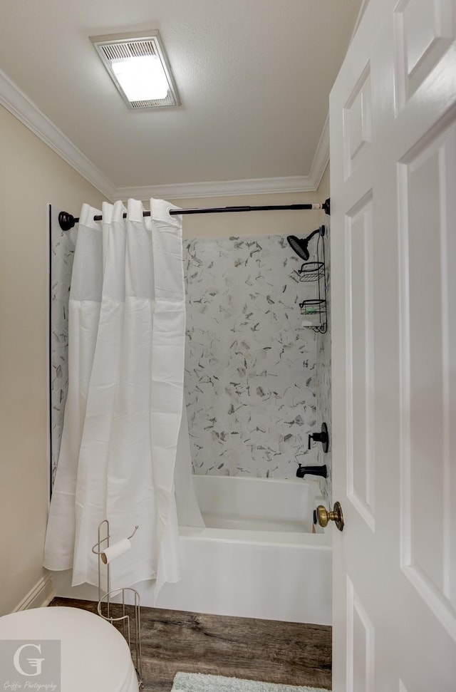 bathroom with shower / tub combo with curtain, crown molding, and toilet