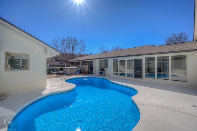 view of pool featuring a hot tub and a patio area