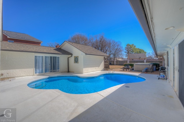 view of swimming pool with a jacuzzi and a patio area