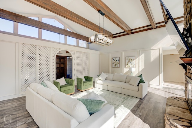 living room featuring beam ceiling, wood-type flooring, high vaulted ceiling, and a chandelier