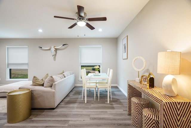 living room featuring ceiling fan and light hardwood / wood-style floors