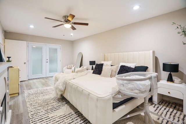 bedroom with french doors, ceiling fan, and light hardwood / wood-style floors