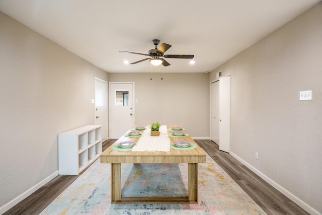 dining space featuring ceiling fan and dark hardwood / wood-style floors