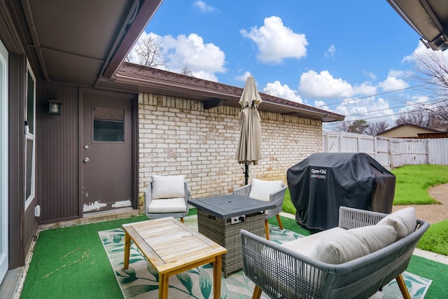 view of patio featuring area for grilling and an outdoor fire pit