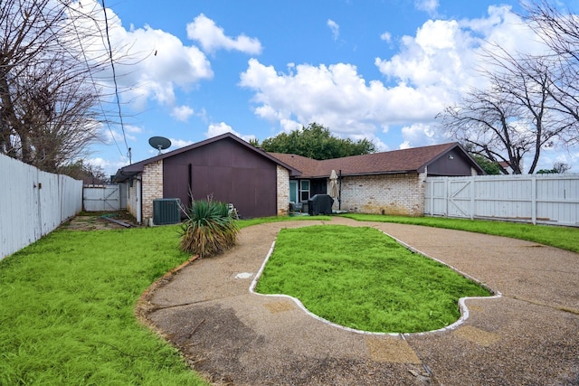 exterior space featuring cooling unit and a yard