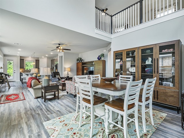 dining room with visible vents, a high ceiling, light wood-style flooring, recessed lighting, and ceiling fan