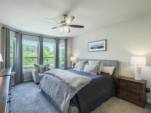 carpeted bedroom with baseboards, visible vents, and ceiling fan