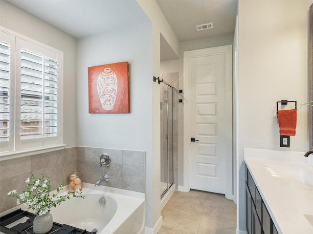 bathroom with tile patterned floors, visible vents, a garden tub, and a shower stall