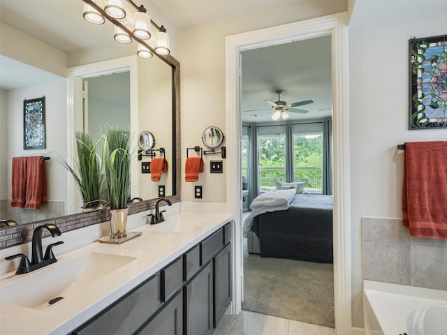 bathroom featuring tile patterned flooring, ensuite bath, a tub to relax in, and a sink