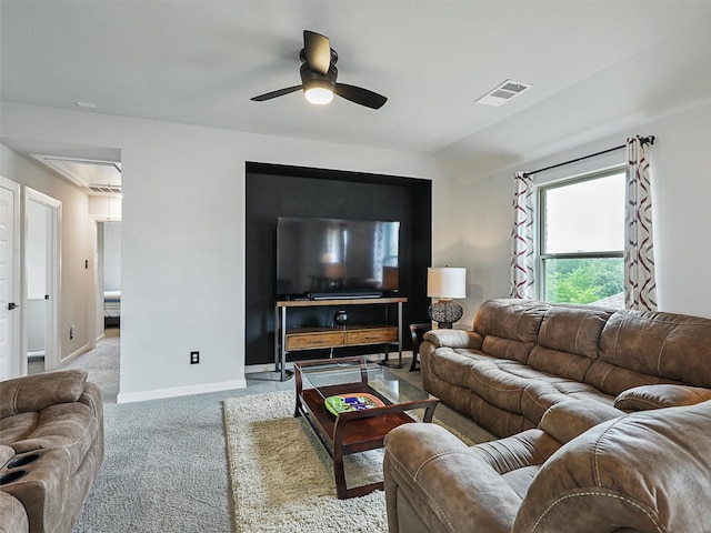 living room featuring visible vents, baseboards, ceiling fan, attic access, and carpet flooring