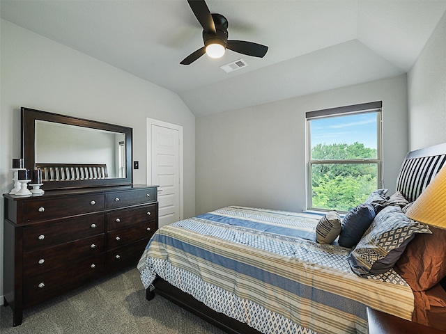 bedroom with vaulted ceiling, a ceiling fan, visible vents, and dark colored carpet