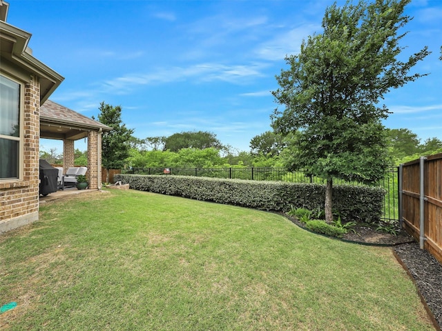 view of yard featuring a patio area and a fenced backyard