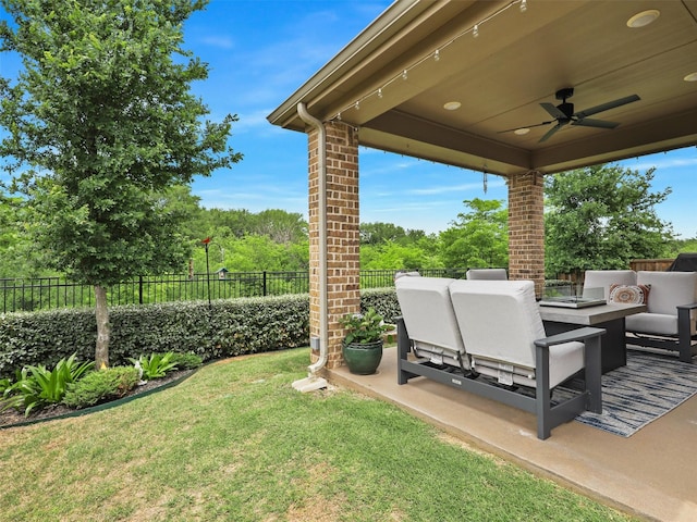 view of yard with ceiling fan, a fenced backyard, outdoor lounge area, and a patio area