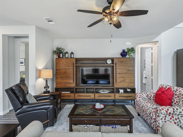 living room featuring a ceiling fan and visible vents