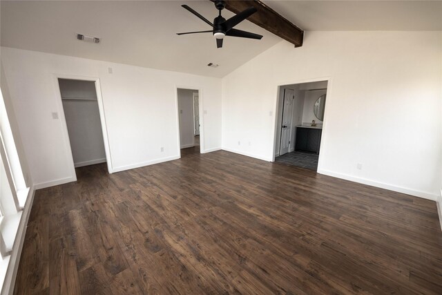 unfurnished bedroom featuring dark wood-type flooring, ceiling fan, ensuite bathroom, and vaulted ceiling with beams